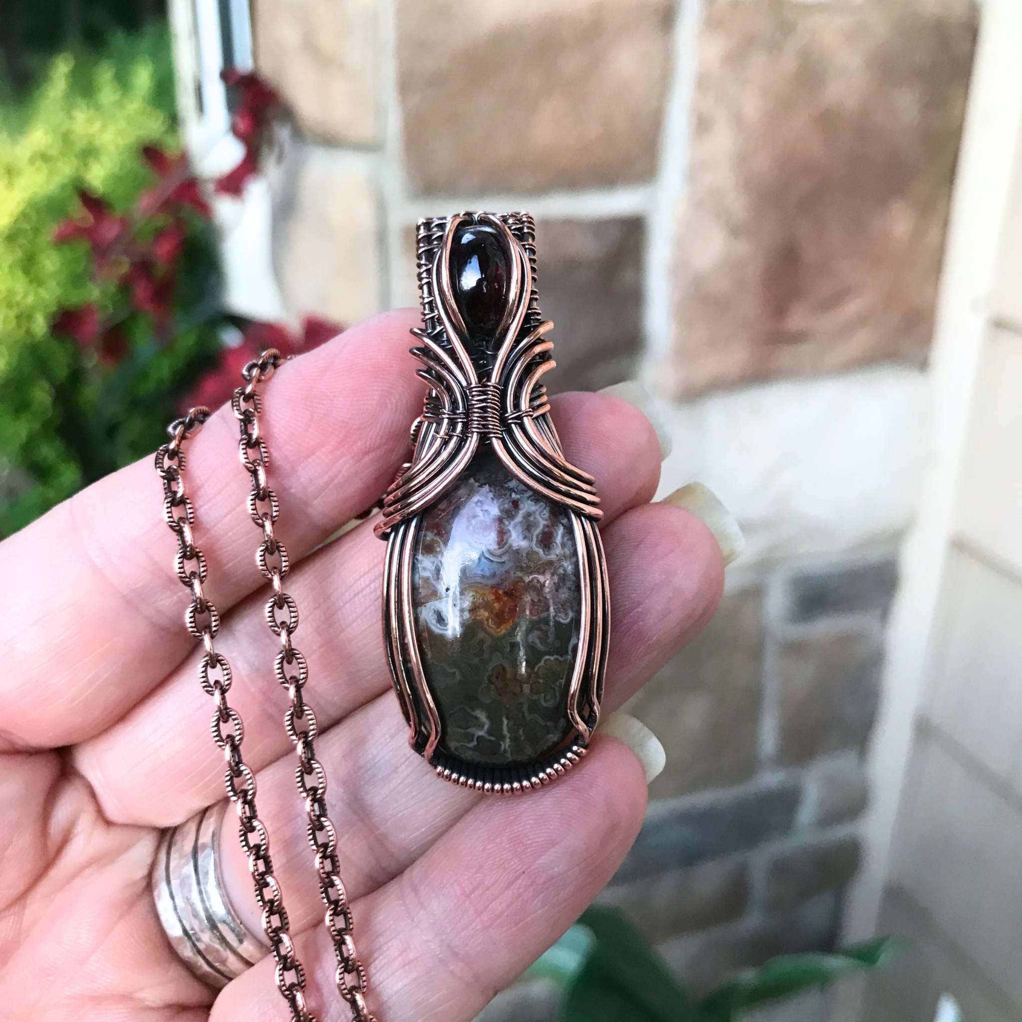 Mexican green crazy lace agate and garnet copper wire wrapped pendant