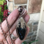 Petrified palm wood root marquis shaped copper wire wrapped pendant